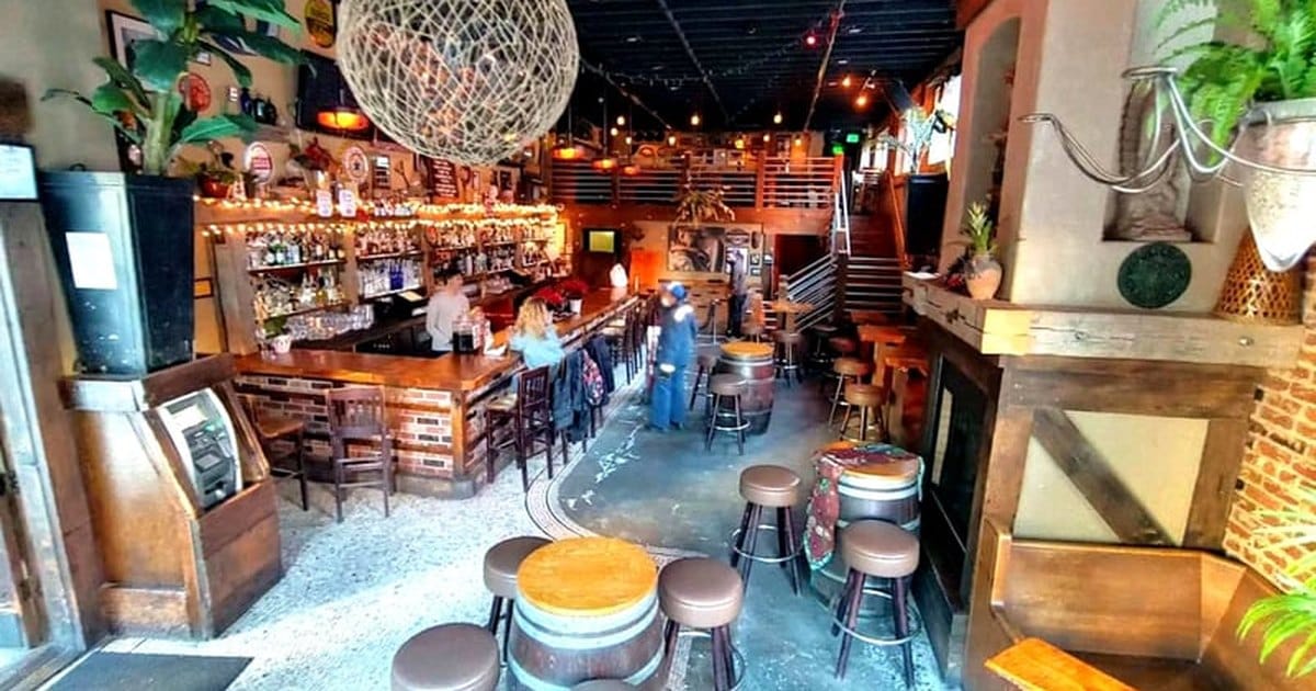 Lower Nob Hill bar and lounge event space in San Francisco with barrel tables, stools and a woven globe lamp