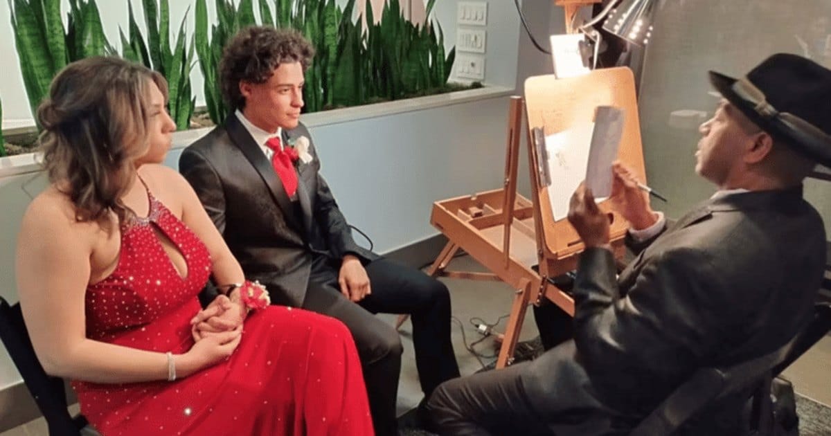 Vallejo-based caricature artist in a black hat sketching a couple at an easel while they sit and pose