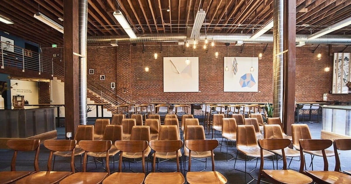 San Francisco event hall with exposed brick walls, redwood rafters and rows of Edison bulb lights