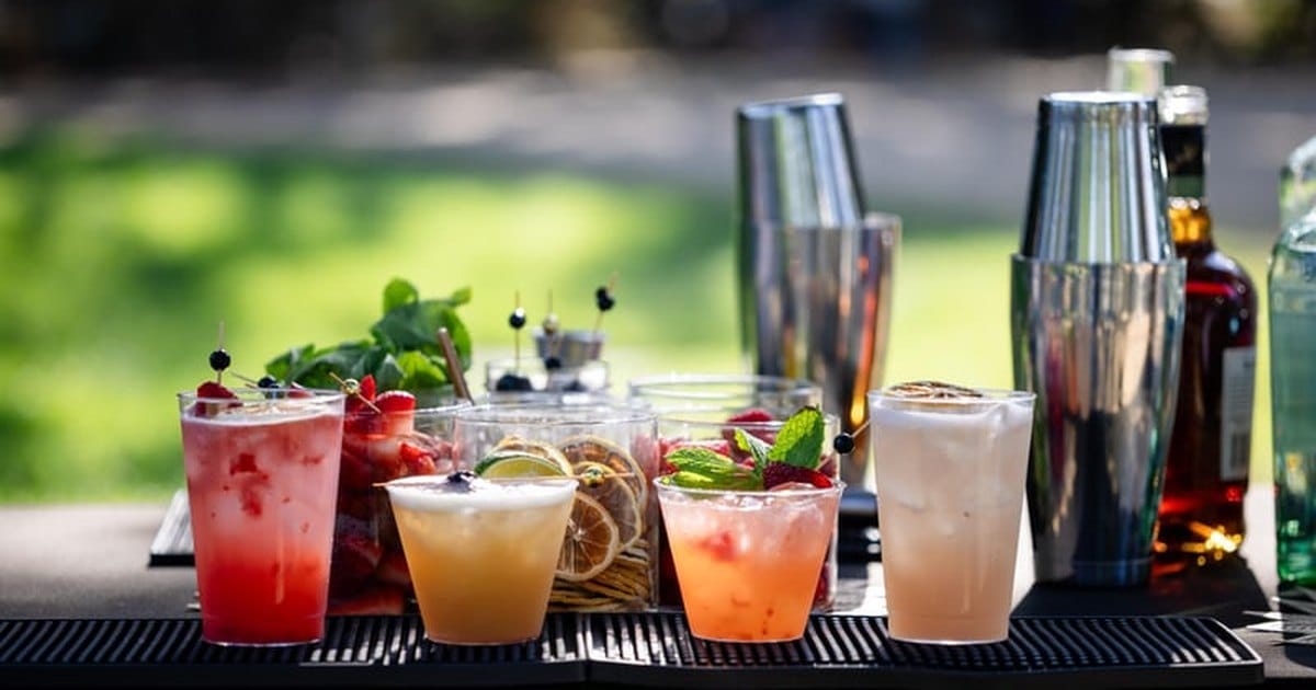 Cocktails and shakers lined up on a portable bar from a Bay Area mobile bar service