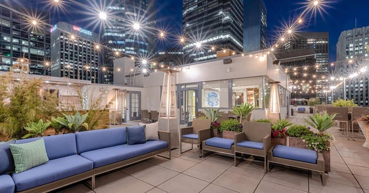 Penthouse rooftop event space in San Francisco with bistro lighting and city views