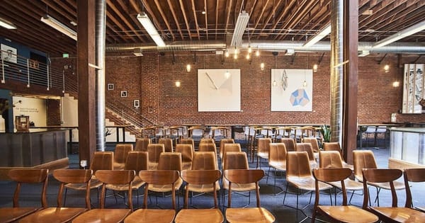 San Francisco event hall with exposed brick walls, redwood rafters and rows of Edison bulb lights